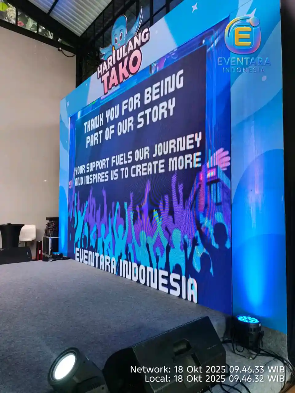 Suasana utama event ulang tahun TAKO ID dengan panggung, videotron, lighting, dan area tamu.